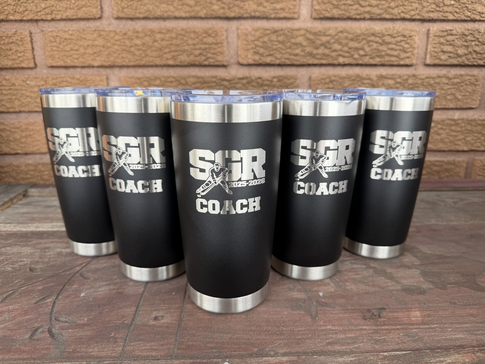 Black tumblers engraved with SGR Coach hockey artwork